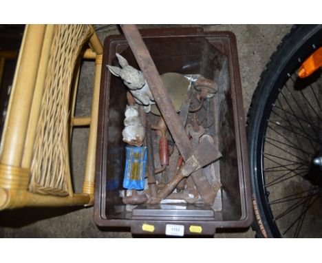 A box of various hand tools and two ornaments in the form of rabbits