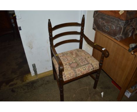 An oak ladder back elbow chair