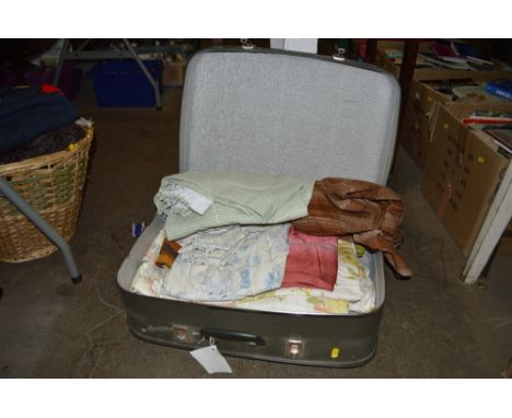 A suitcase containing vintage curtains