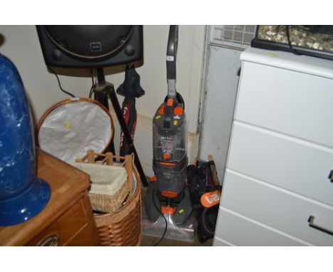 A Vax carpet cleaner with a bag of accessories