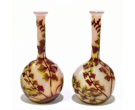 GALLÉ; a pair of cameo glass bottle vases, each decorated with trailing floral detail on a mottled ground, embossed signature