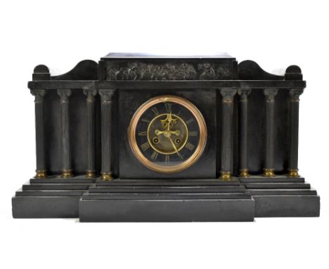 A 19th century black slate eight day mantel clock, of architectural form with visible escapement and Roman numeral chapter ri