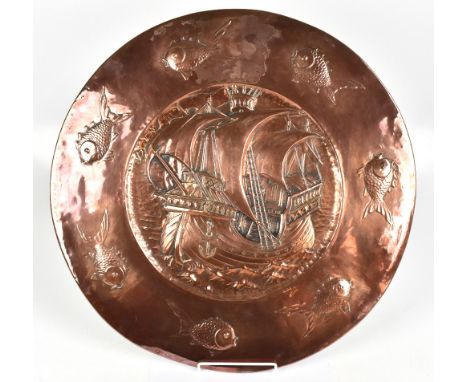 ATTRIBUTED TO JAMES SMITHIES; an Arts &amp; Crafts copper charger with repoussé decoration depicting a central galleon flanke