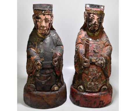 A pair of Chinese archaic style carved and polychrome painted figures of nobleman on oval bases, height 64cm (2)Additional In