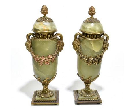 A pair of French gilt brass and green onyx vases and covers, each with twin Cernunnos mask mounts joined by fruiting vines, o