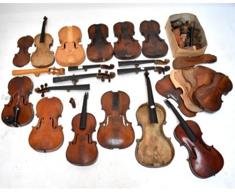 A viola (for restoration), a quantity of violin bodies, necks with scrolls, parts, etc.