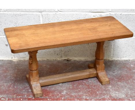 ROBERT 'MOUSEMAN' THOMPSON; a carved oak refectory type coffee table with adzed top, raised on octagonal balustrades terminat