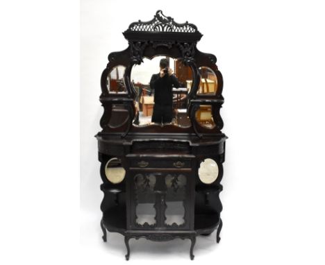 A Victorian carved mahogany mirror back dresser, the raised back with five shaped and bevelled mirror plates and two open she