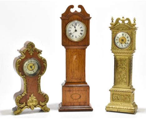 An early 20th century gilt brass mantel clock modelled as a longcase clock, the Arabic numeral enamel dial manufactured by 'A