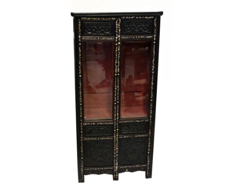 A 20th century Chinese ebonised cabinet, the pair of half glazed doors with bevelled plates above carved detail, inside mothe