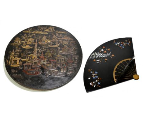 A 19th century Chinese lacquered circular tabletop decorated with buildings and boats, diameter 40.5cm, and a lacquered papie