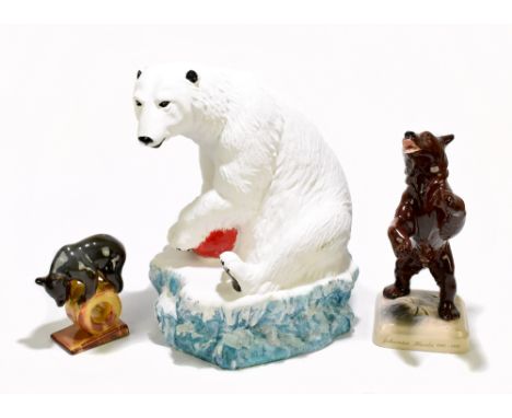 A large painted ceramic model of a seated Polar bear with ball, height 37cm, together with a Russian ceramic figure of a bear