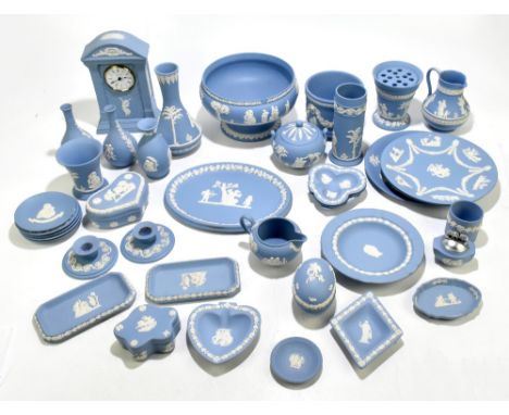 WEDGWOOD; a collection of thirty-nine pieces of blue jasperware including mantel clock, height 23cm, baluster vase, height 19