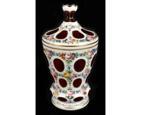 An early 20th century Bohemian flashed glass lidded jar with hand painted floral detail on an opaque and ruby glass body, hei
