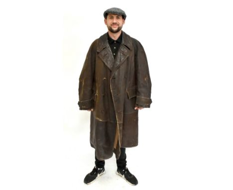 A gentleman's vintage tan leather motorcycle coat, length approx 118cm.Additional InformationThe coat is heavily worn through