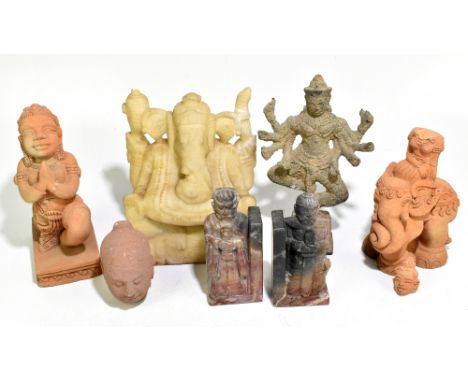 A carved alabaster figure of Ganesha, together with a pair of Chinese carved soapstone figures of deities, a carved sandstone