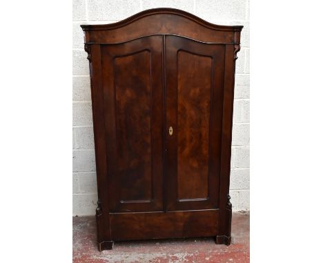 A late 19th century walnut two door hanging wardrobe, with serpentine top, on bracket feet, height 185cm, width 110cm, depth 