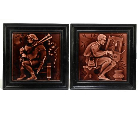 A pair of Victorian ceramic tiles depicting musicians with embossed floral detail to reverse, each in an ebonised frame, 19 x