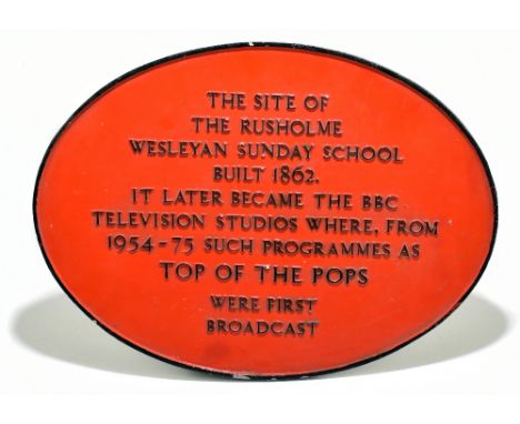 A painted cast metal plaque stating 'The site of Rusholme Wesleyan Sunday School built 1862. It later became the BBC Televisi