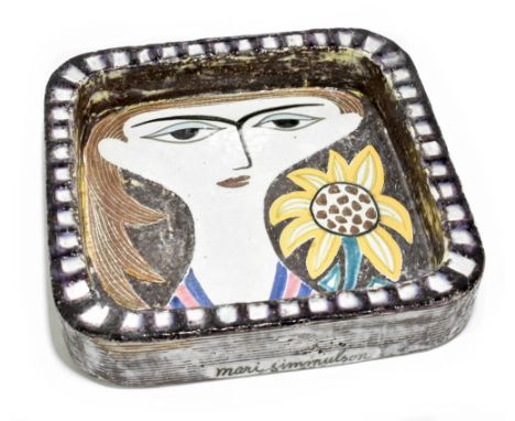 MARI SIMMULSON FOR UPSALA-EKEBY; an art pottery bowl of square form decorated in enamels with abstract face beside floral spr