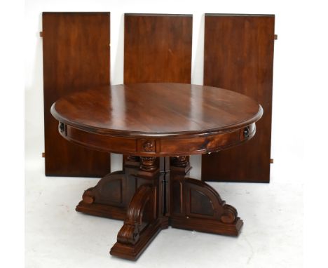 A 19th century mahogany circular extending dining table, the circular top with three spare leaves, on four column supports an