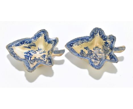 CAUGHLEY; a pair of late 18th century blue and white leaf shaped pickle dishes decorated in a variant of the willow scene, le