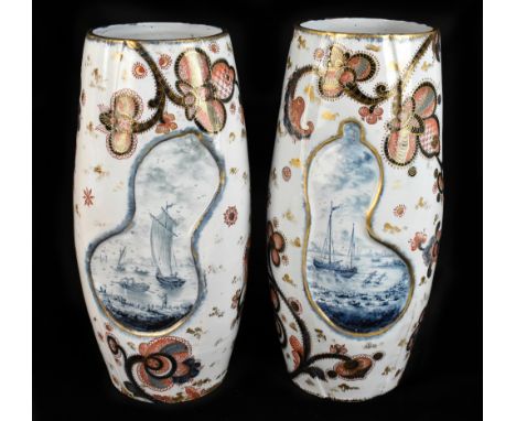 Emile Galle (1846-1904); a pair of large ceramic vases each with moulded panels decorated with Delft harbour scenes, inside I