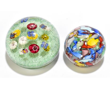 Two Italian paperweights including an example with floating butterfly canes above floral canes on a green bed, bears two indi
