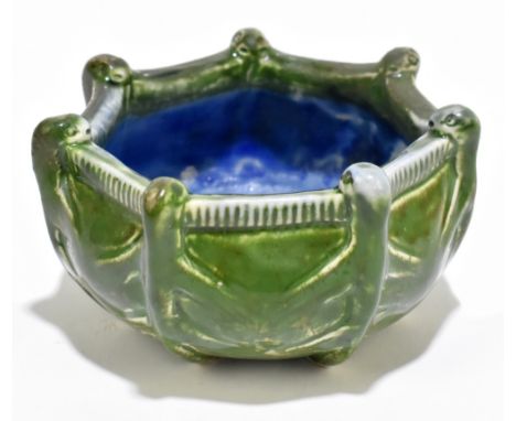 MARTIN BROTHERS, SOUTHALL LONDON; a green glazed art pottery heptagon shaped bowl, relief decorated with seven creatures clim