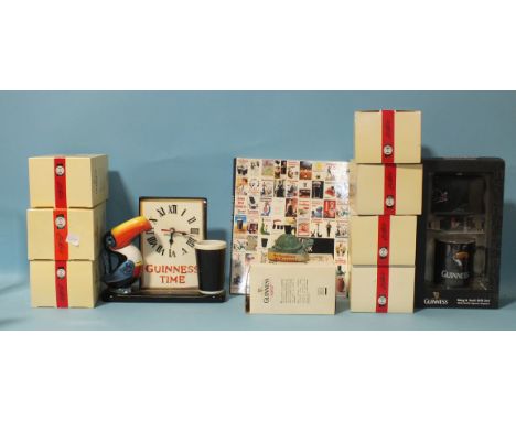 A modern "Guinness Time" ceramic clock, eight Guinness collectable figurines, a Guinness mug and sock gift set, (all boxed) a