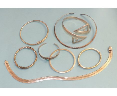 A 925 silver armlet of geometric form, another silver armlet, three other silver bracelets, a neck chain, a silver torque, 15