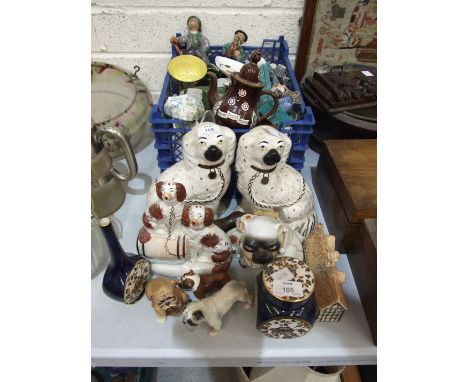 A pair of Staffordshire dog ornaments, 23.5cm high, another of two spaniels, one sitting on a barrel, 21cm, both with crazing