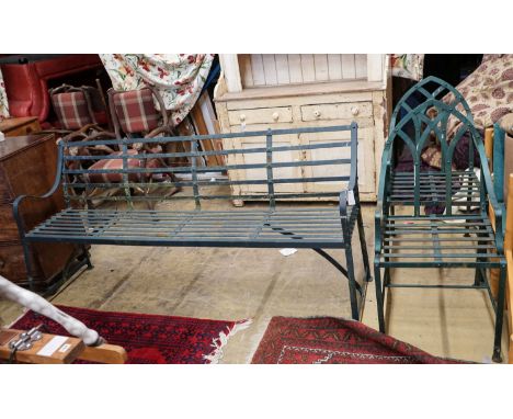 A green painted wrought iron garden bench, length 186cm, depth 46cm, height 92cm together with two Gothic style painted wroug
