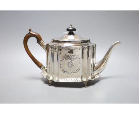 A George III bright cut engraved oval teapot and matching stand, Soloman Hougham, London, 1794, stand 19.3 cm, gross 20oz.