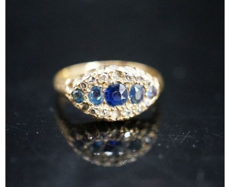 An early 20th century 18ct gold, graduated five stone sapphire and rose cut diamond set cluster ring, size J/K, gross weight 