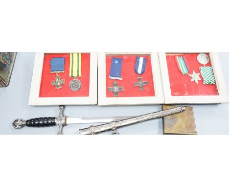 A Canadian First War Christie Brown and Co printed biscuit tin, reproduction framed medals, a trench art brass cigarette case