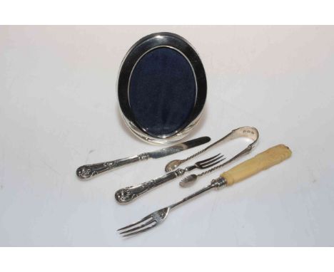 Silver pickle fork, Sheffield 1876, miniature silver knife and fork, George Unite, London 1836, silver tongs and small photo 