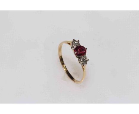 18 carat gold ruby and diamond three-stone ring, size R.