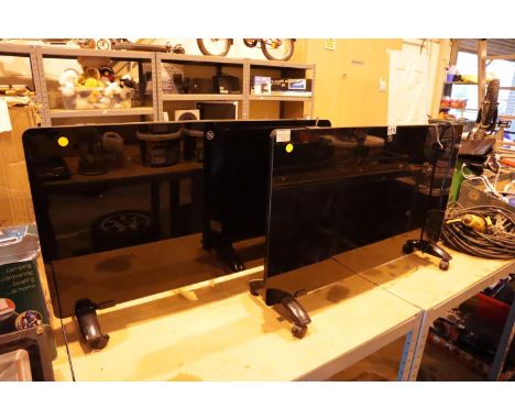 Two black freestanding 200w glass panelled heaters.  Not available for in-house P&amp;P, contact Paul O'Hea at Mailboxes on 0