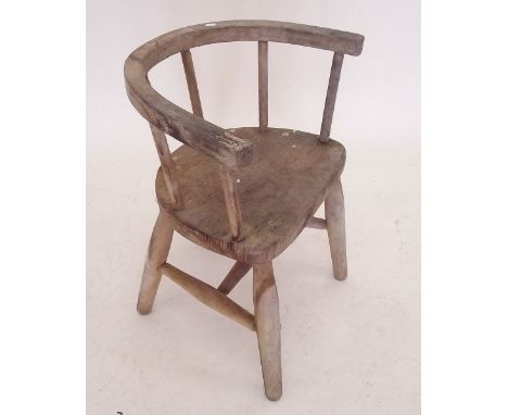 A childs chair with stick back