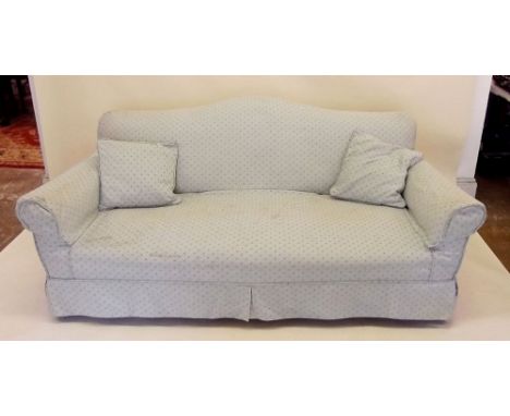 An early 20th century sofa with loose covers on cabriole supports