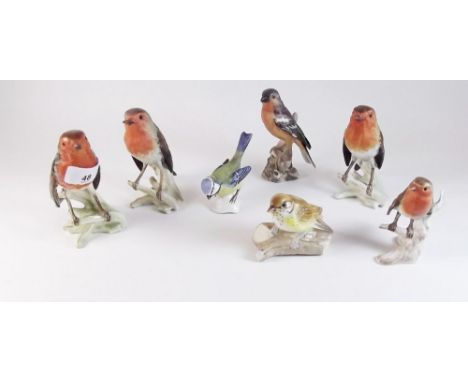 Four Goebel robins, a blue tit and a chaffinch