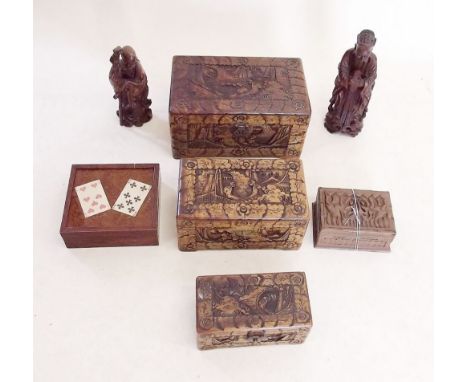 A collection of wooden items including four Eastern carved boxes, two oriental carved figures and a playing card storage box