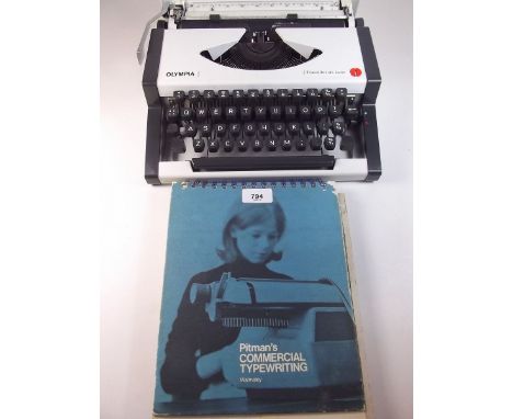 An Olympia vintage portable typewriter with instructions