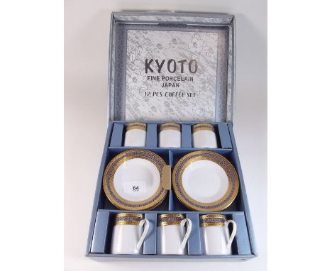 A Kyoto Japanese porcelain coffee set with gilt borders, comprising six cups and saucers - boxed