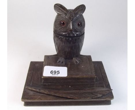 An early 20th century owl form treen inkwell with pen rest