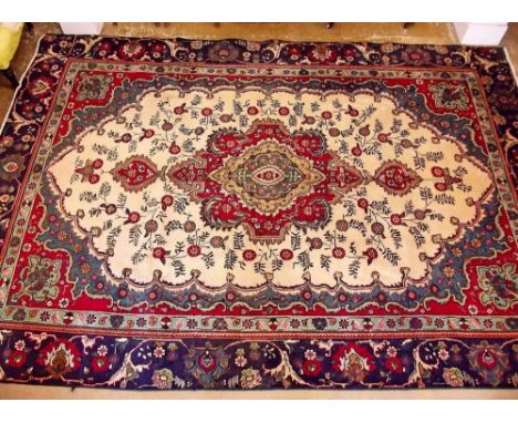 A blue and red ground Persian Tabriz carpet with traditional medallion design 314 x 215cm