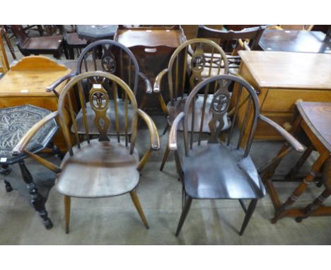 A set of four Ercol Golden Dawn elm and beech fleur de lys chairs 