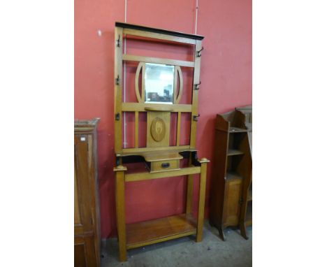 An Arts and Crafts light oak hallstand 
