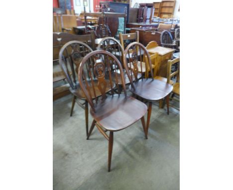 A set of four Ercol Golden Dawn elm and beech fleur de lys chairs 